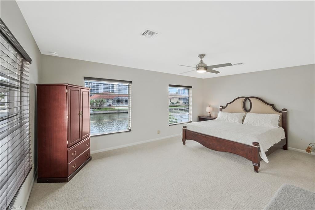 Bedroom featuring ceiling fan and light colored carpet
