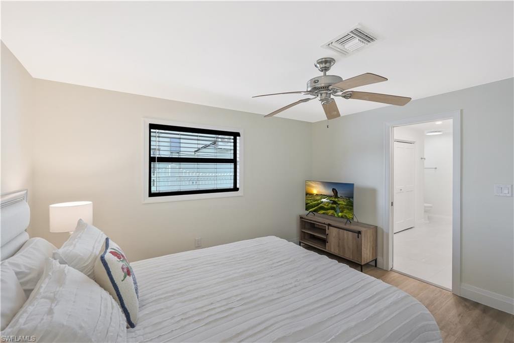 Bedroom with light wood-style floors and ceiling fan