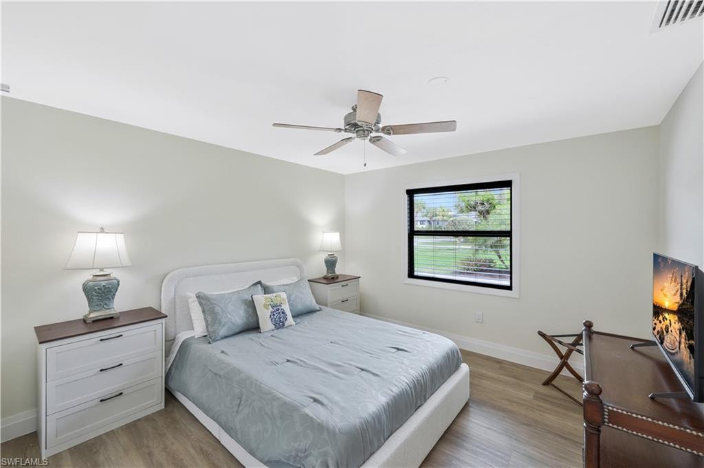 Bedroom with light wood-style flooring and a ceiling fan