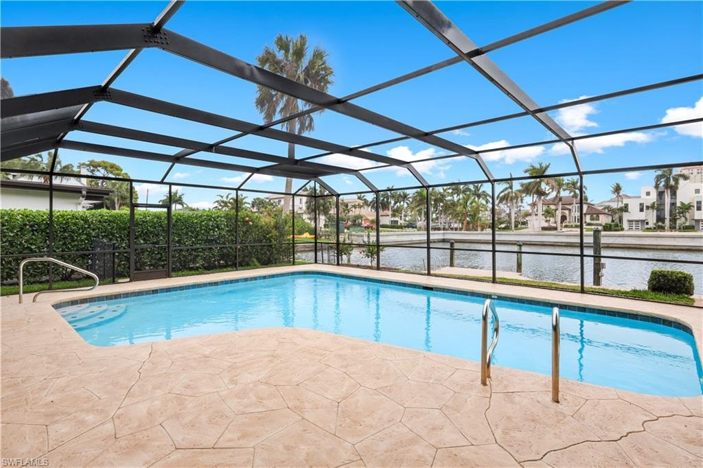 Outdoor pool featuring a sunroom, a lanai, a water view, a patio, and a residential view