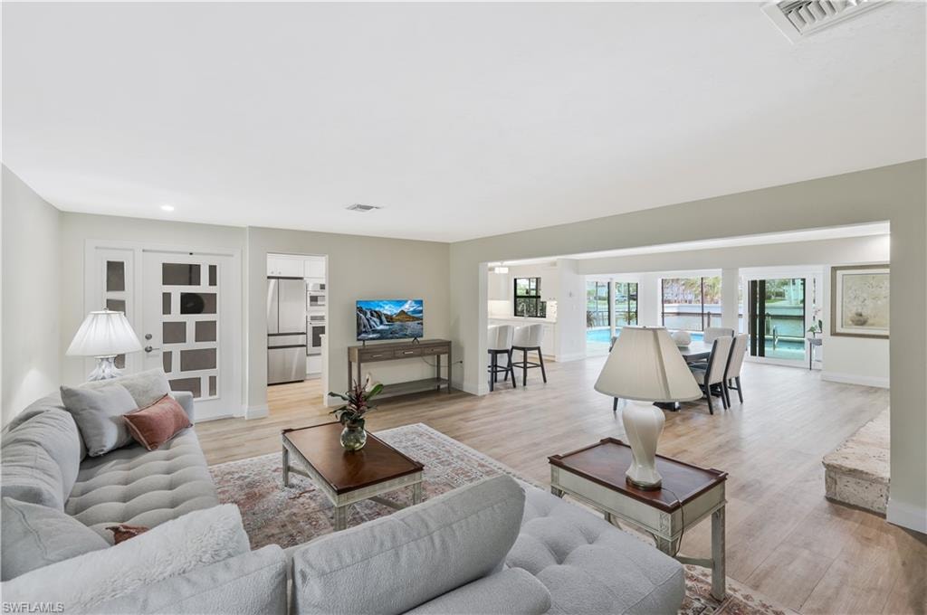 Living room with light wood finished floors and baseboards