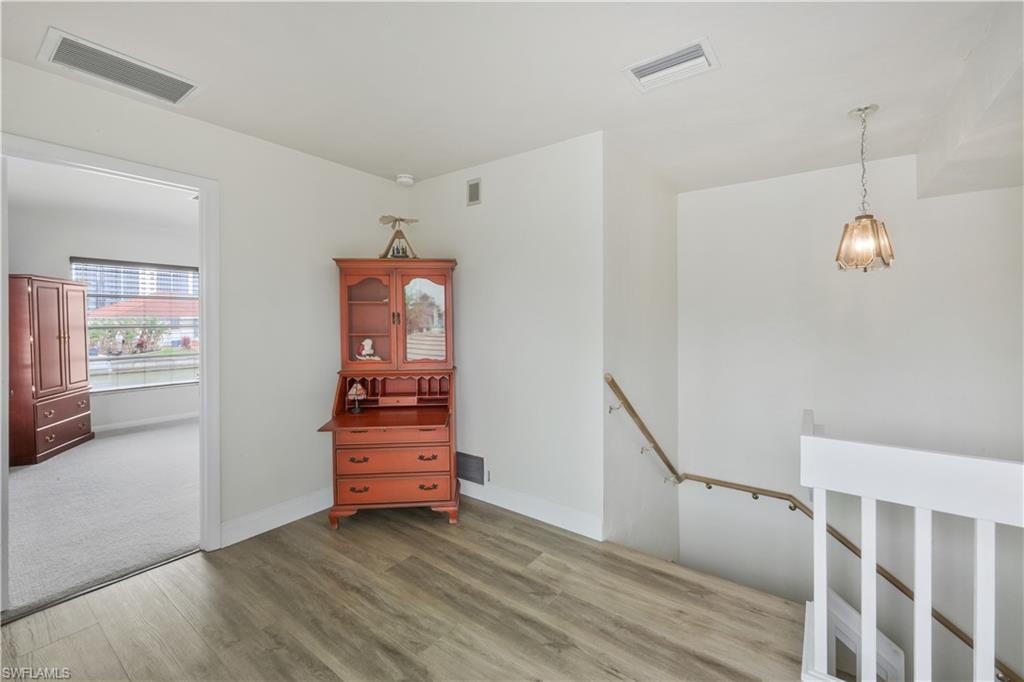 Unfurnished room with light wood-style floors and baseboards
