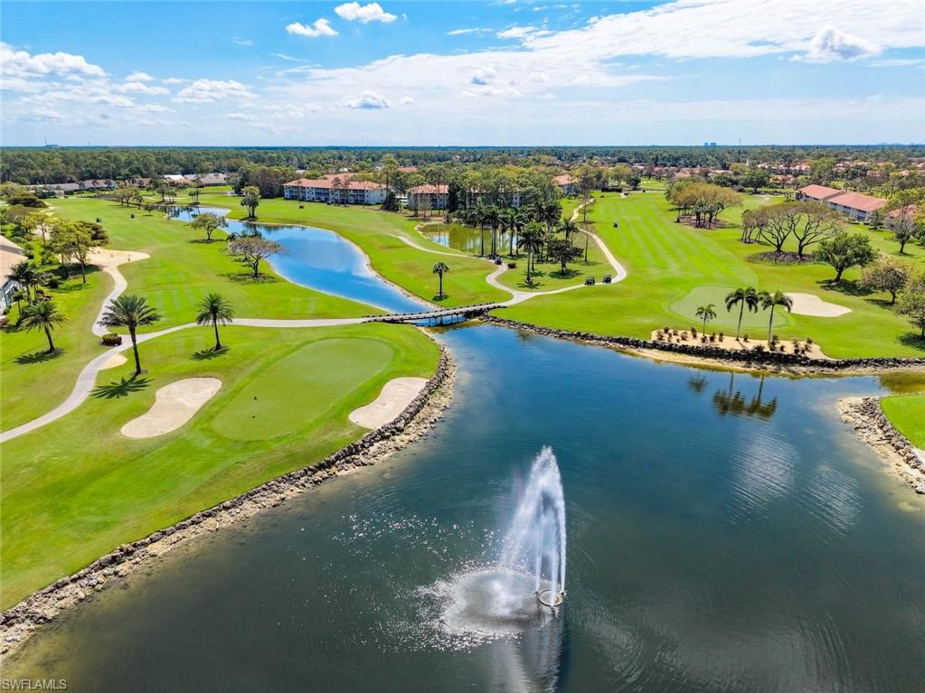 Aerial view of residential area featuring a local golf course and a large body of water