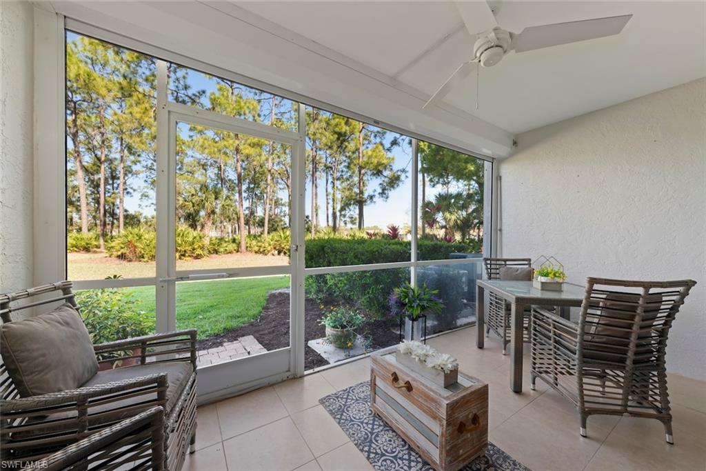 Sunroom / solarium with a ceiling fan and outdoor dining area