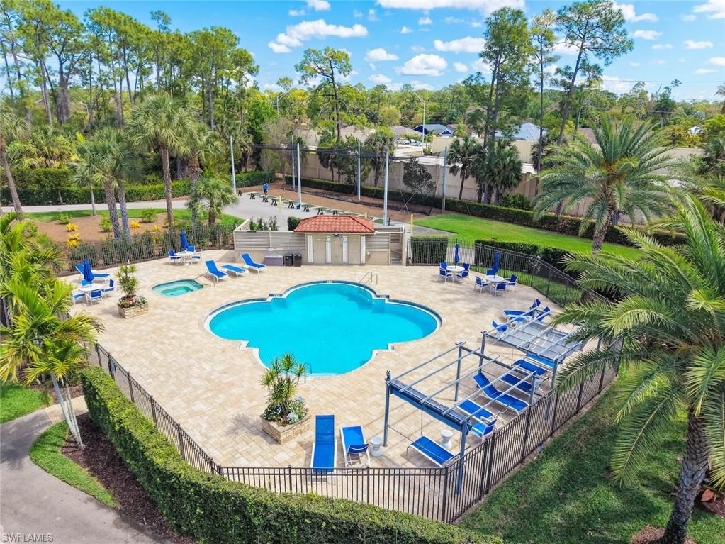 Community pool with a patio and a hot tub