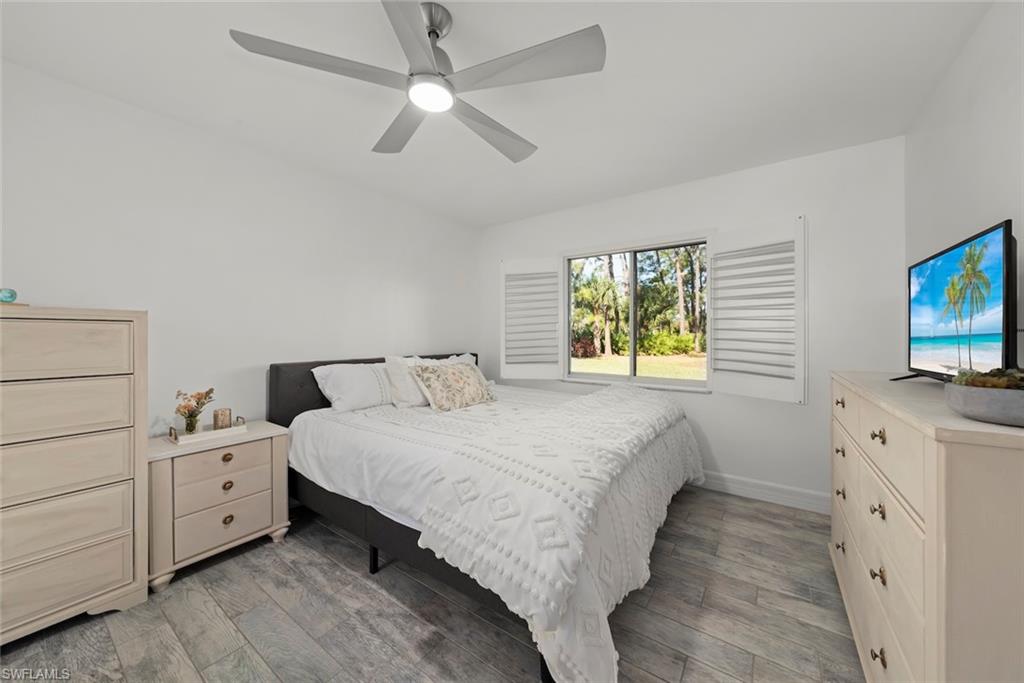 Bedroom with light wood-style flooring and a ceiling fan