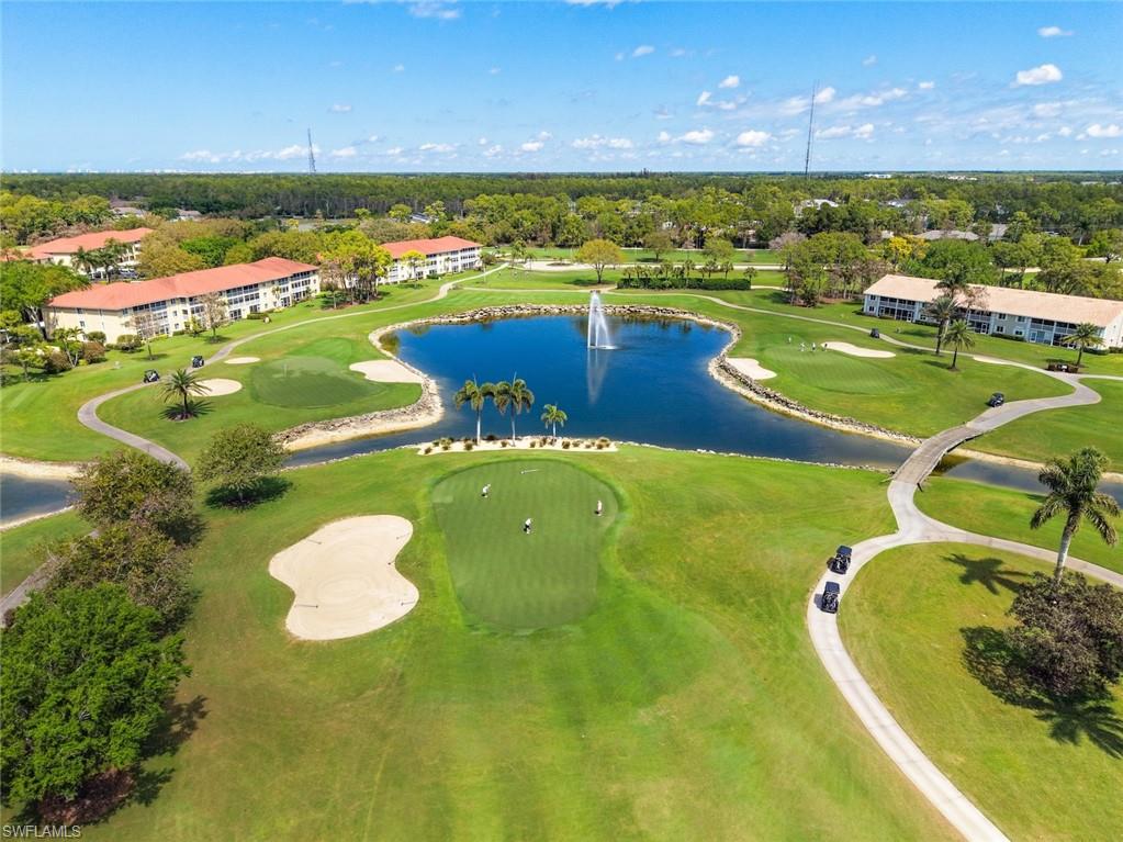 Aerial view of a golf course and a nearby body of water