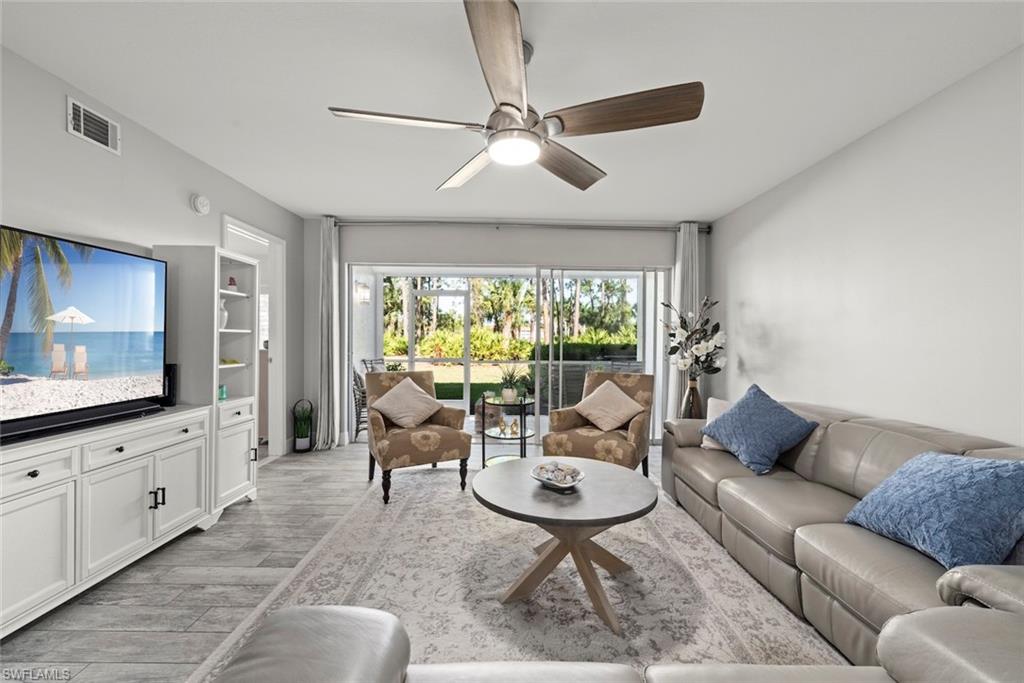 Living room featuring ceiling fan and light wood-style flooring