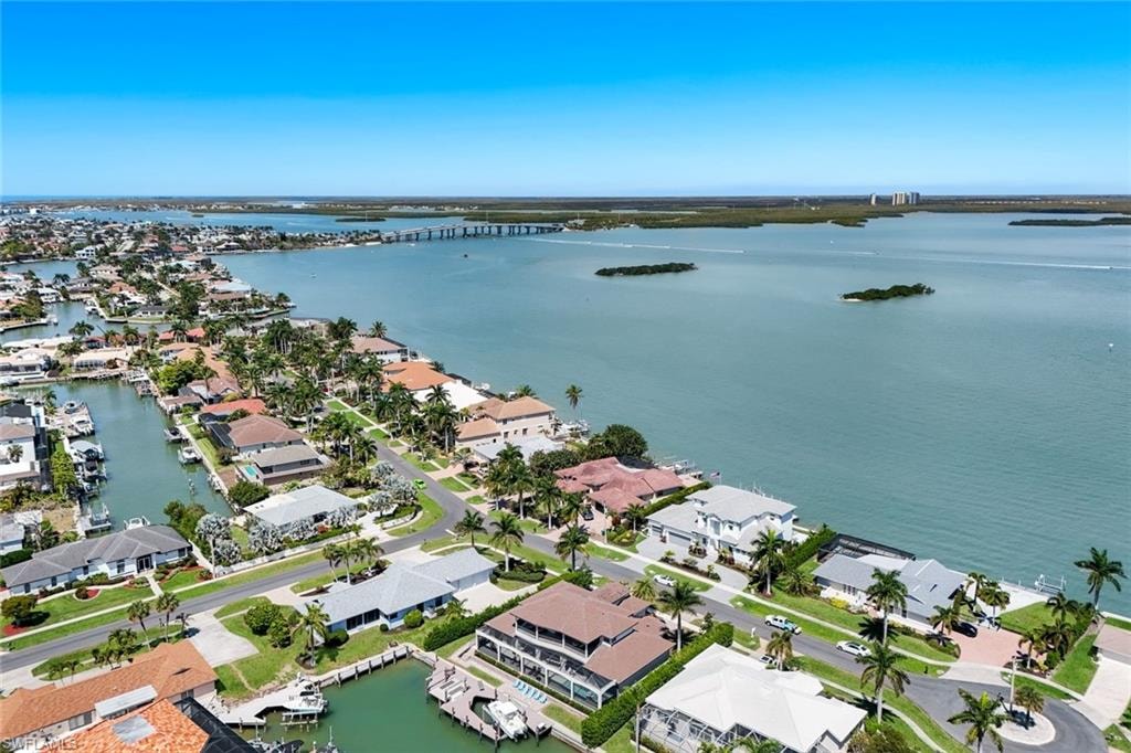 Aerial view of residential area featuring a notable bridge and a nearby body of water