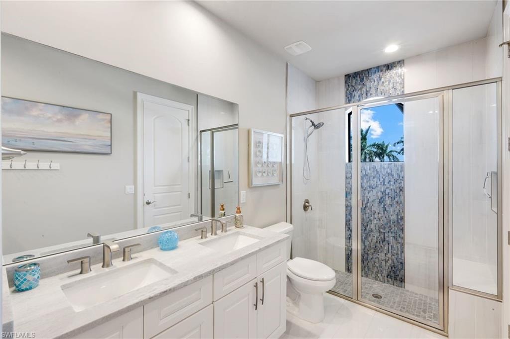Bathroom with double vanity and a shower stall