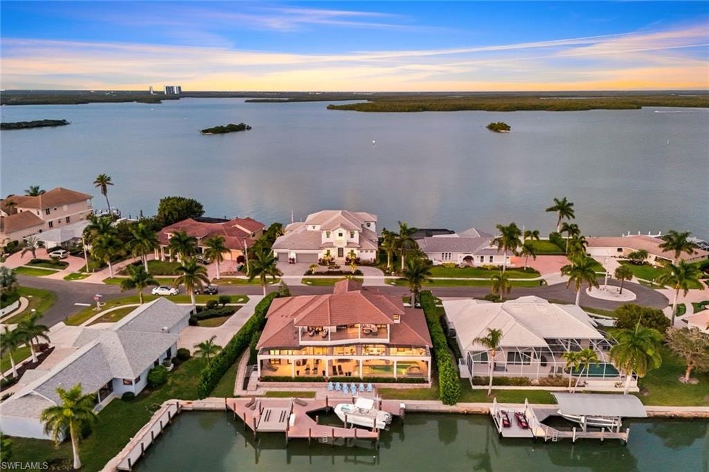 Aerial view at dusk of a water view and a residential view