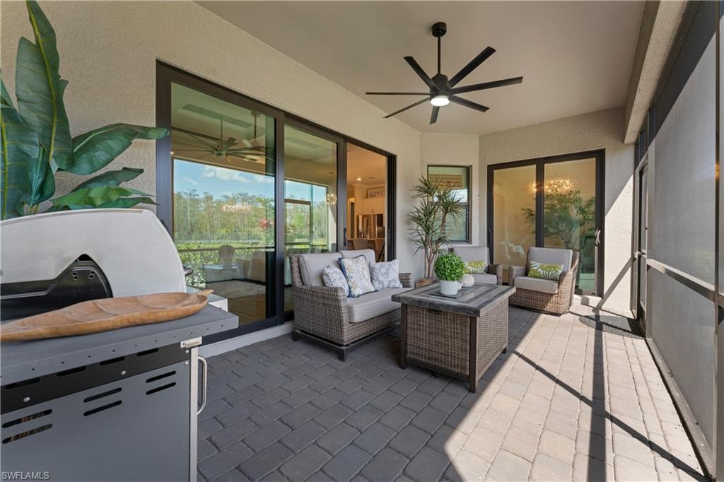 Sunroom featuring a ceiling fan, an outdoor lounge area, and a patio area
