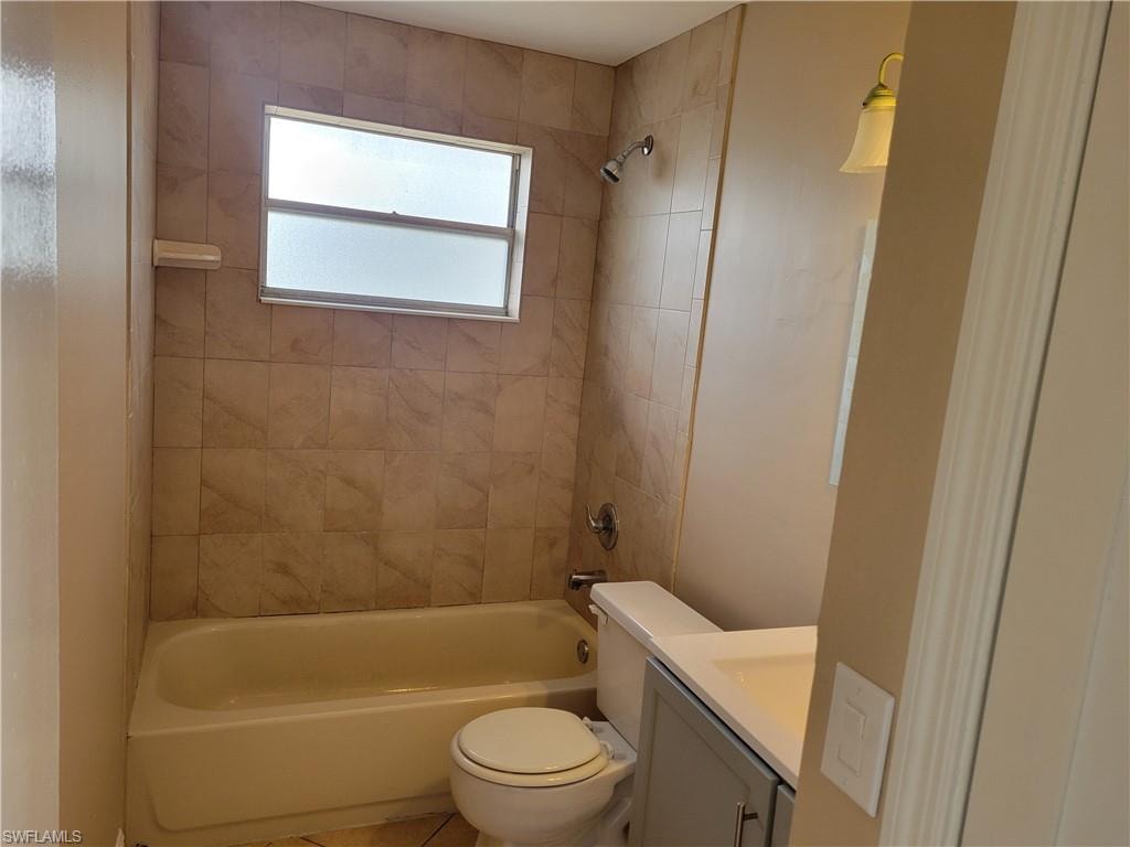 Full bathroom with vanity,  shower combination, and tile patterned flooring