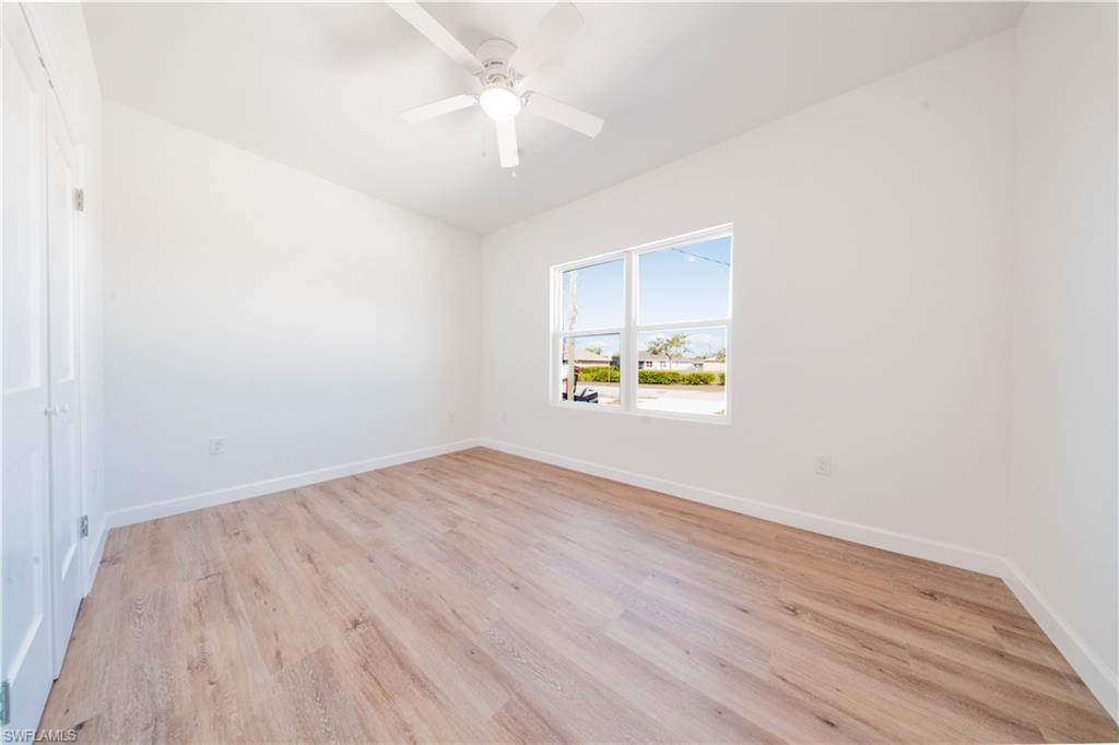 Empty room with light wood-style flooring and a ceiling fan