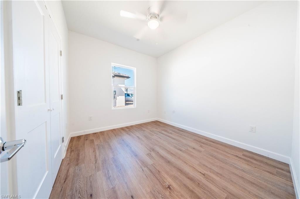 Unfurnished room with light wood-type flooring and a ceiling fan