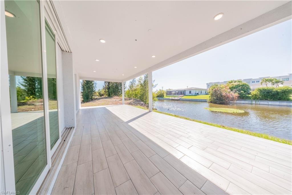 Deck with a water view and a patio area