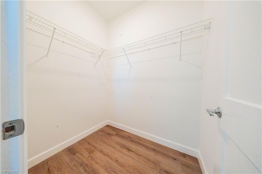 Walk in closet featuring light wood finished floors