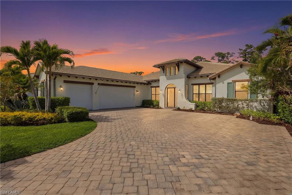 Mediterranean / spanish-style home featuring an attached garage, stucco siding, decorative driveway, and a tiled roof