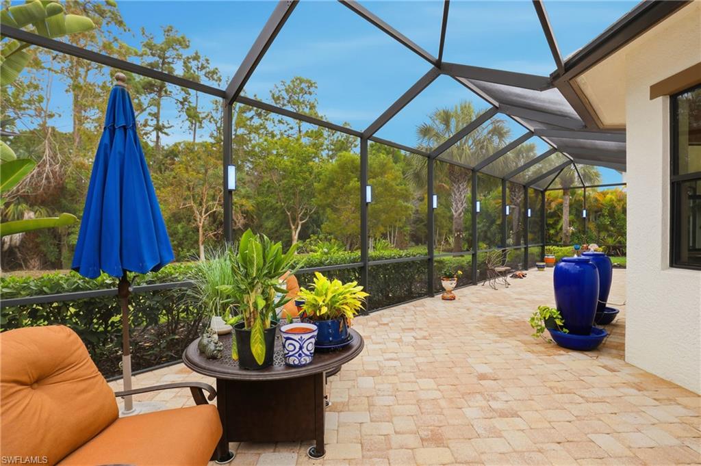 View of patio with a sunroom and glass enclosure