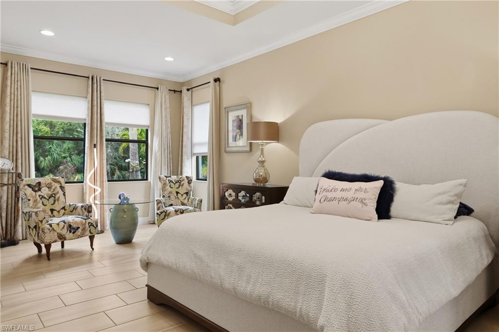 Bedroom with ornamental molding, wood finish floors, and recessed lighting