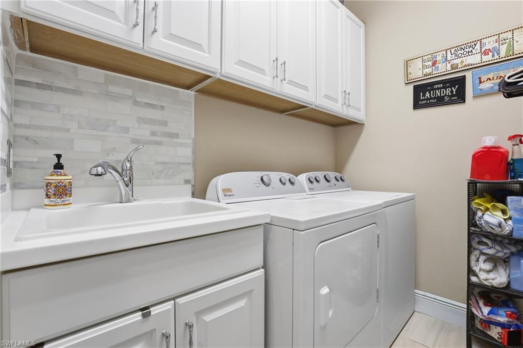 Laundry room featuring cabinet space and separate washer and dryer