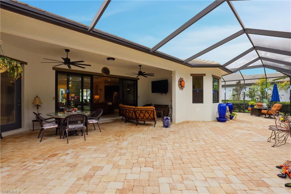 View of patio / terrace featuring a sunroom, outdoor lounge area, a lanai, and a ceiling fan