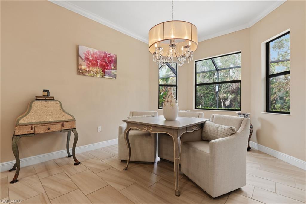 Dining space featuring crown molding, suspended lighting, and wood finish floors