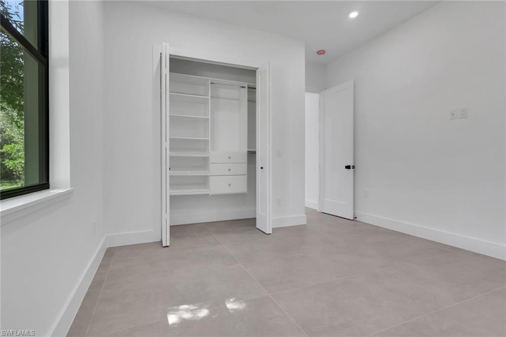 Contemporary room featuring a built-in closet system with shelving and drawers