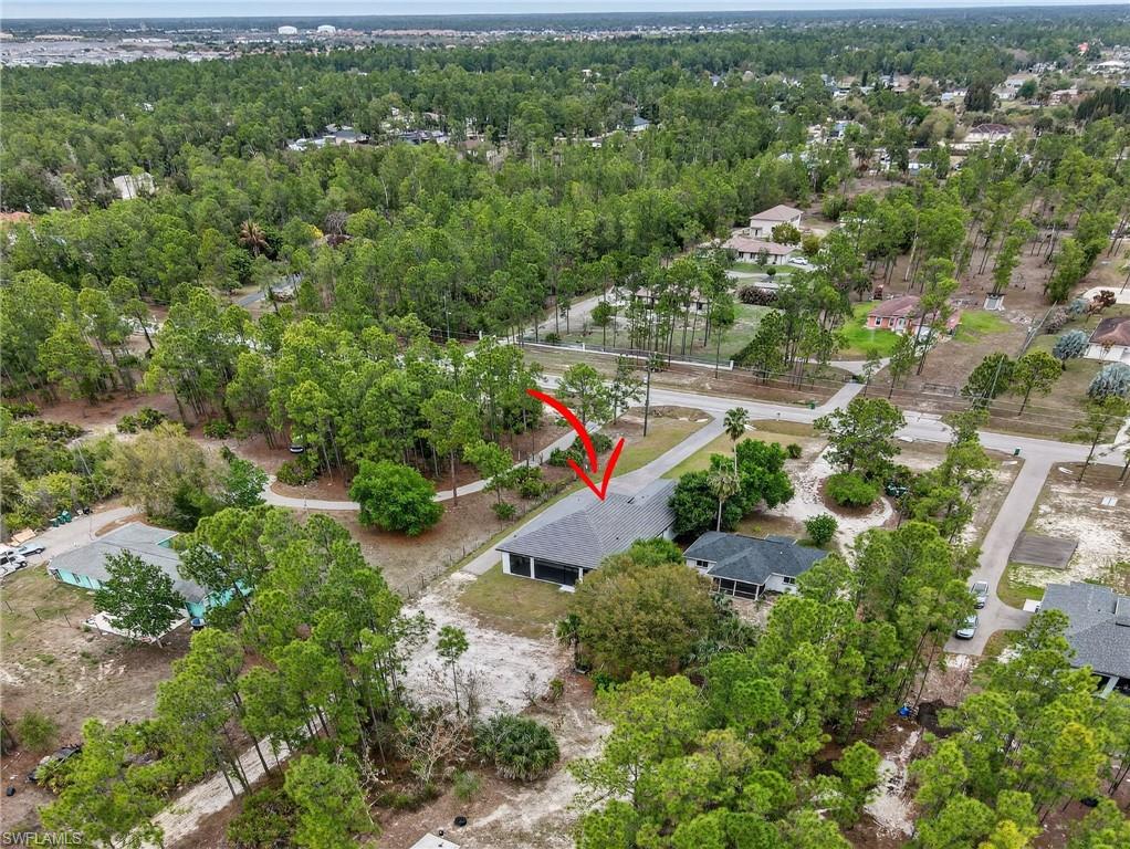 Aerial perspective showcasing a single-story residence with a dark gray shingle roof