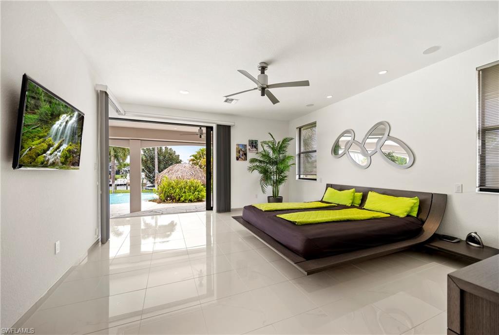 Bedroom with access to outside, ceiling fan, recessed lighting, and light tile patterned floors