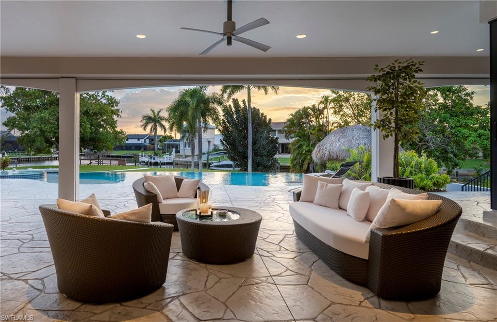 View of patio / terrace with an outdoor lounge area, an outdoor pool, and a ceiling fan