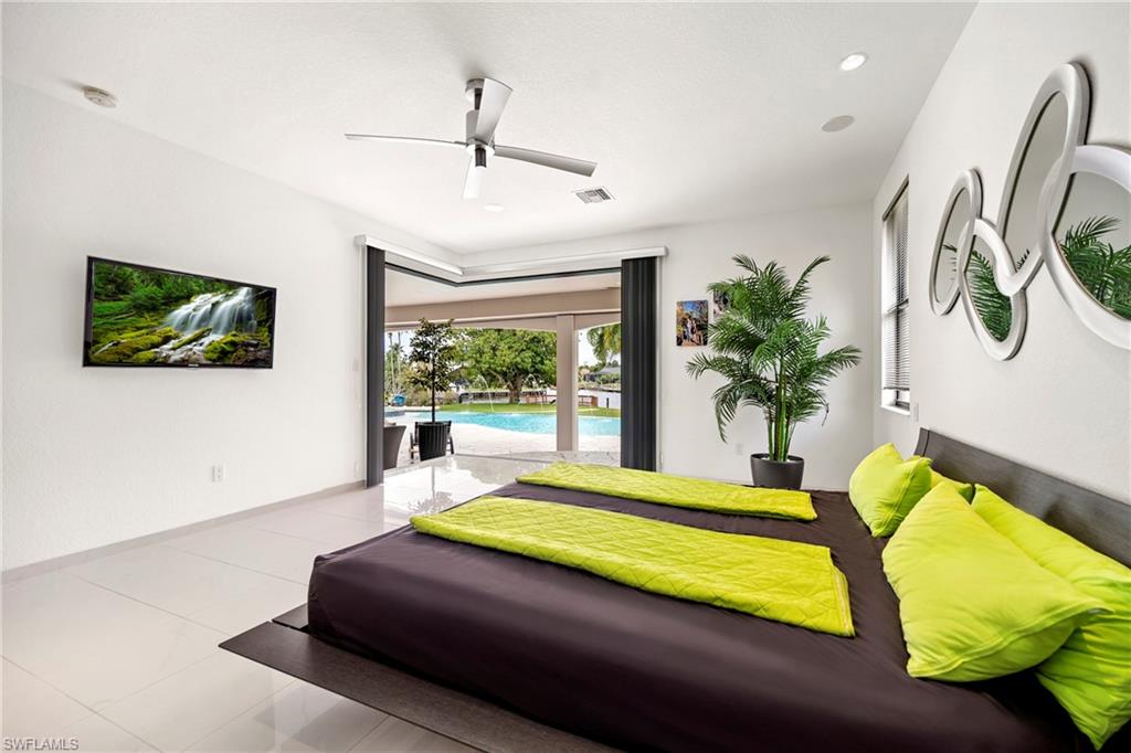 Bedroom featuring access to exterior, ceiling fan, tile patterned floors, and recessed lighting