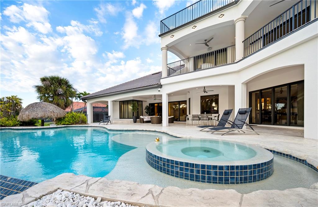 Integrated pool / spa with a patio, a balcony, and outdoor lounge area