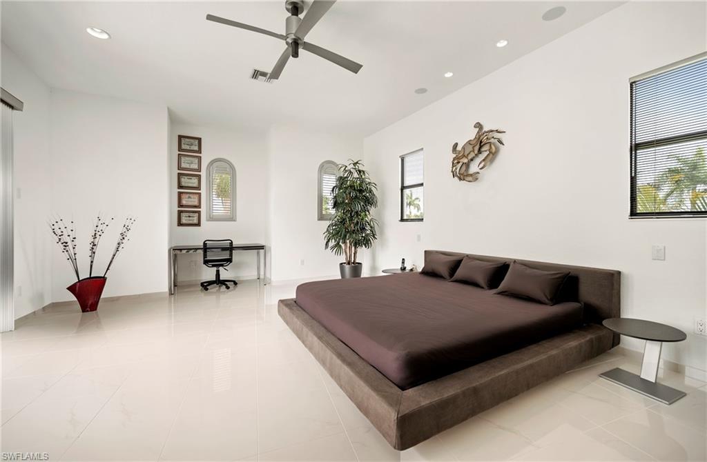Guest Bedroom featuring recessed lighting and       a ceiling fan as well access to a balcony facing front of the house