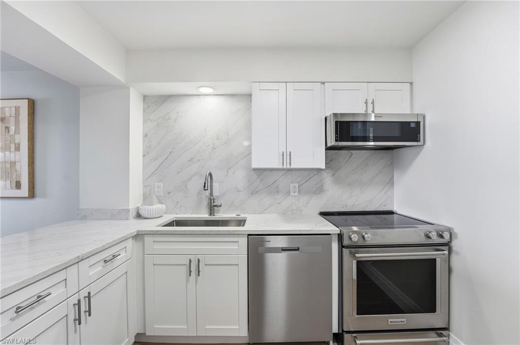 The newly renovated kitchen features new cabinetry and updated appliances for both style and function.
