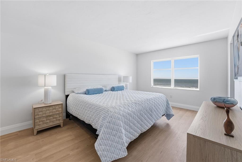 The primary bedroom offers comfort, style, and a peaceful coastal atmosphere.