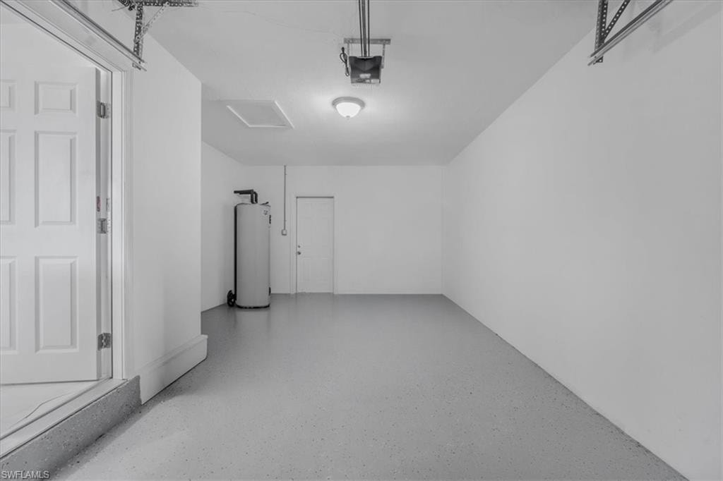 Garage with water heater and a garage door opener