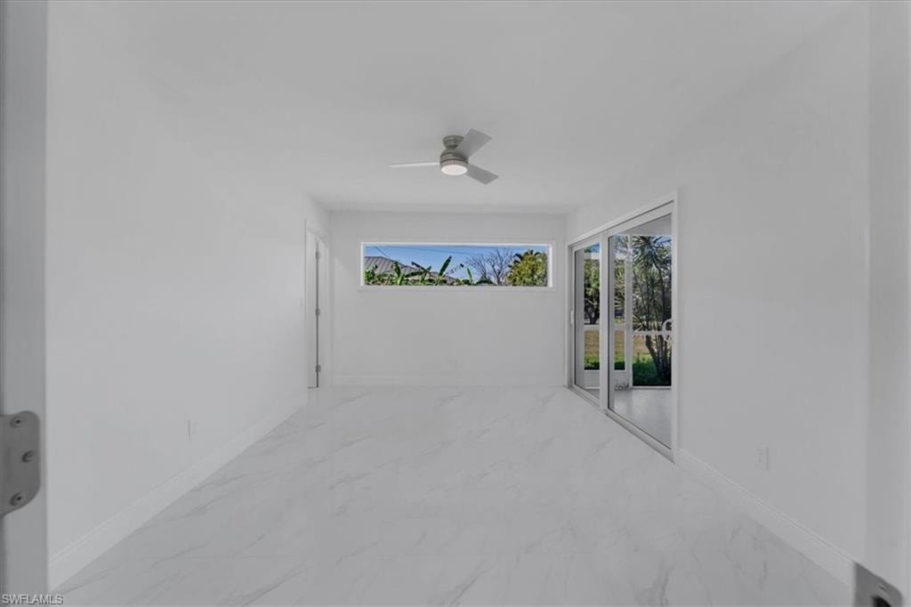 View of patio / terrace featuring a ceiling fan and a sunroom