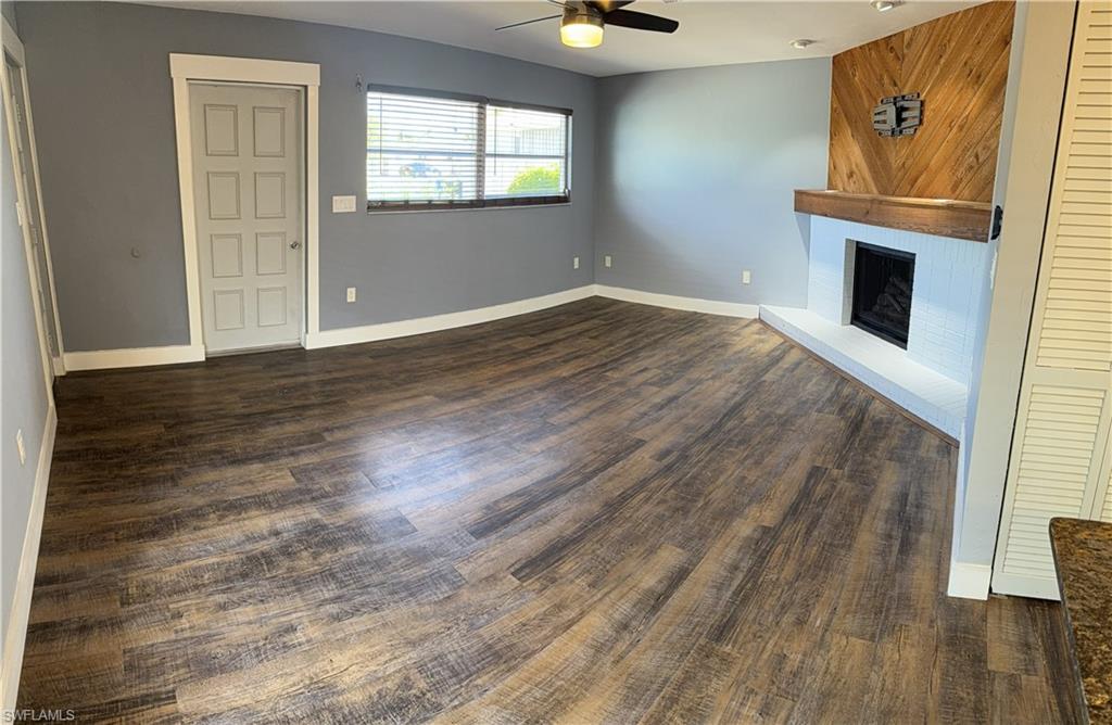 Guest House, ceiling fan, and dark wood finished floors