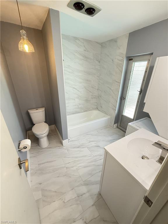 Guest House, Full bathroom featuring light marble finish flooring, vanity, and shower / tub combination