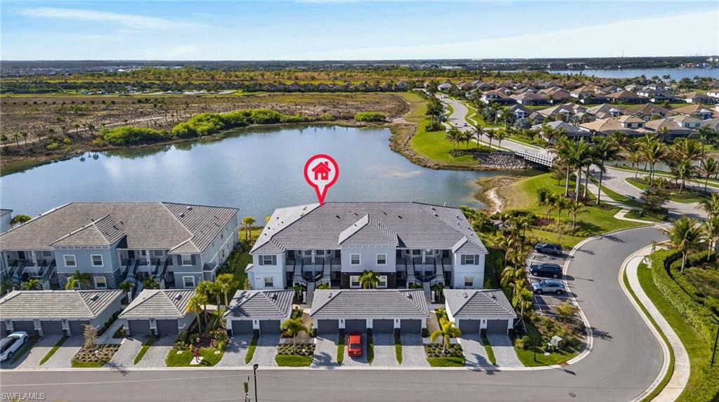 Aerial perspective of suburban area featuring a nearby body of water