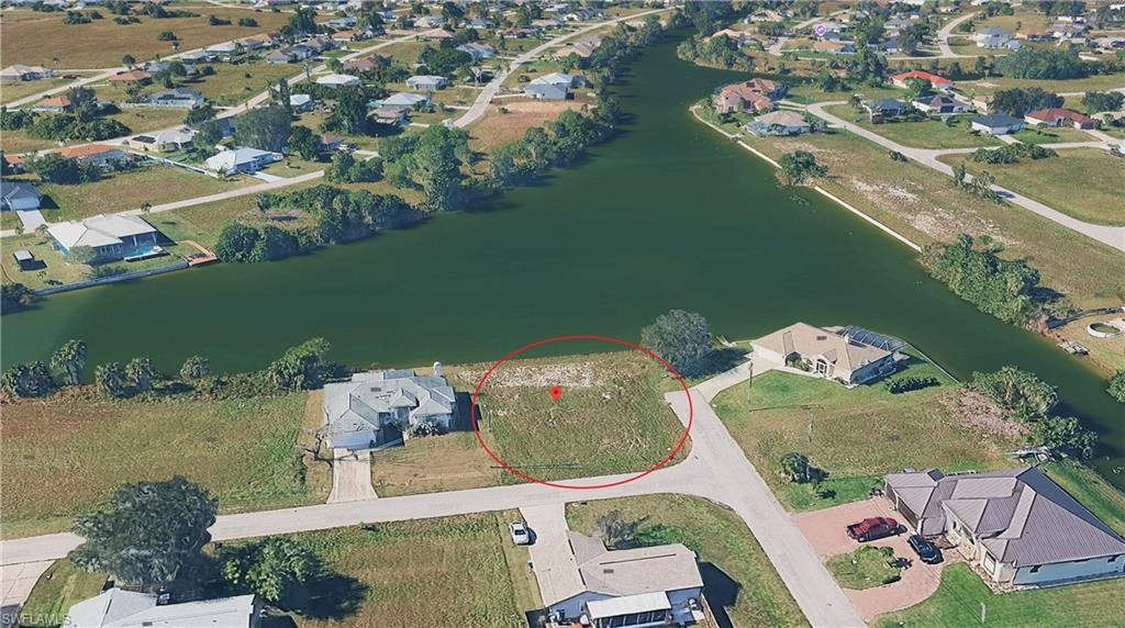 View of property location featuring nearby suburban area and a nearby body of water