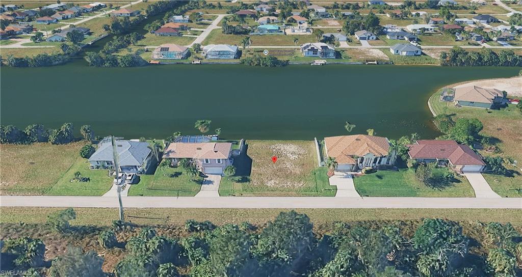 Aerial overview of property's location featuring nearby suburban area and a large body of water