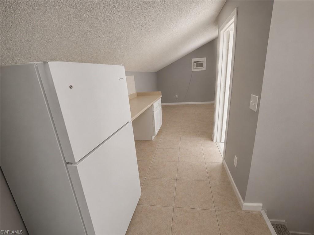 7374 Laundry area featuring washer hookup, light tile patterned floors, and electric dryer hookup