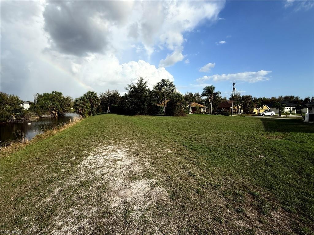 View of green lawn with a water view