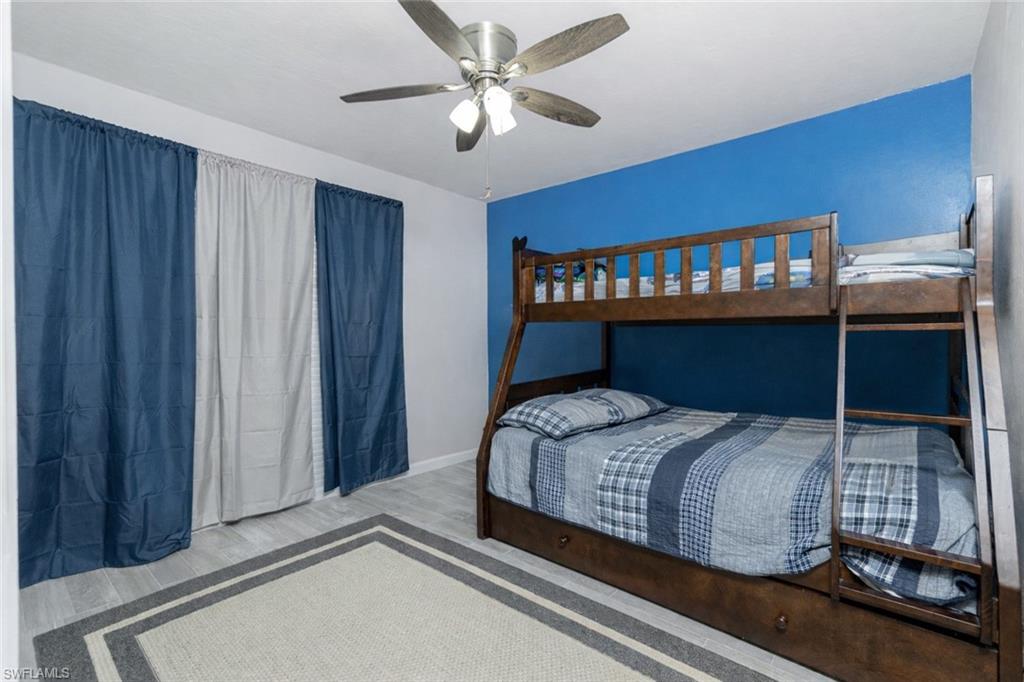 Bedroom with wood finished floors and ceiling fan