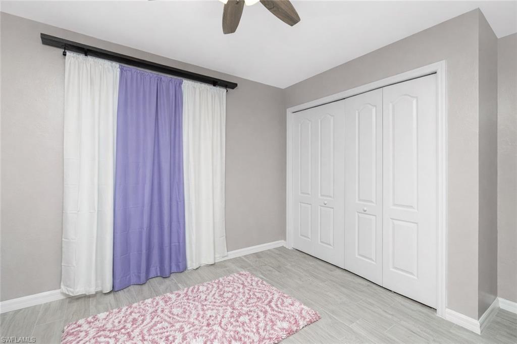 Unfurnished bedroom featuring ceiling fan, light wood finished floors, and a closet