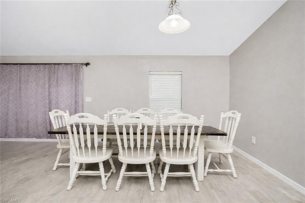 Dining room featuring light wood-style flooring and baseboards