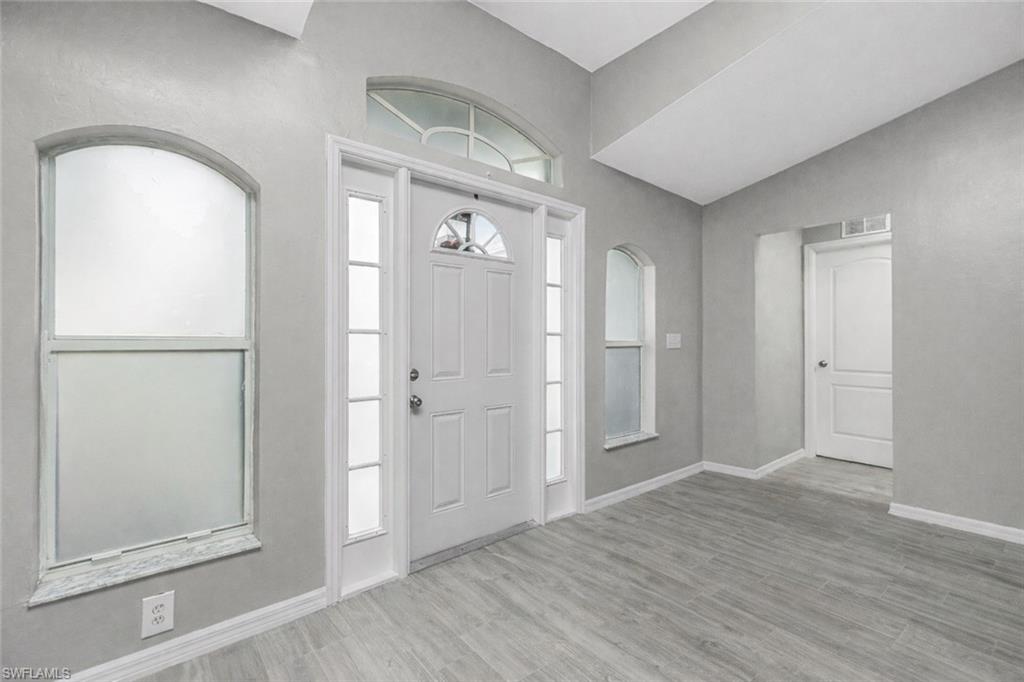 Entrance foyer featuring baseboards and light wood-type flooring