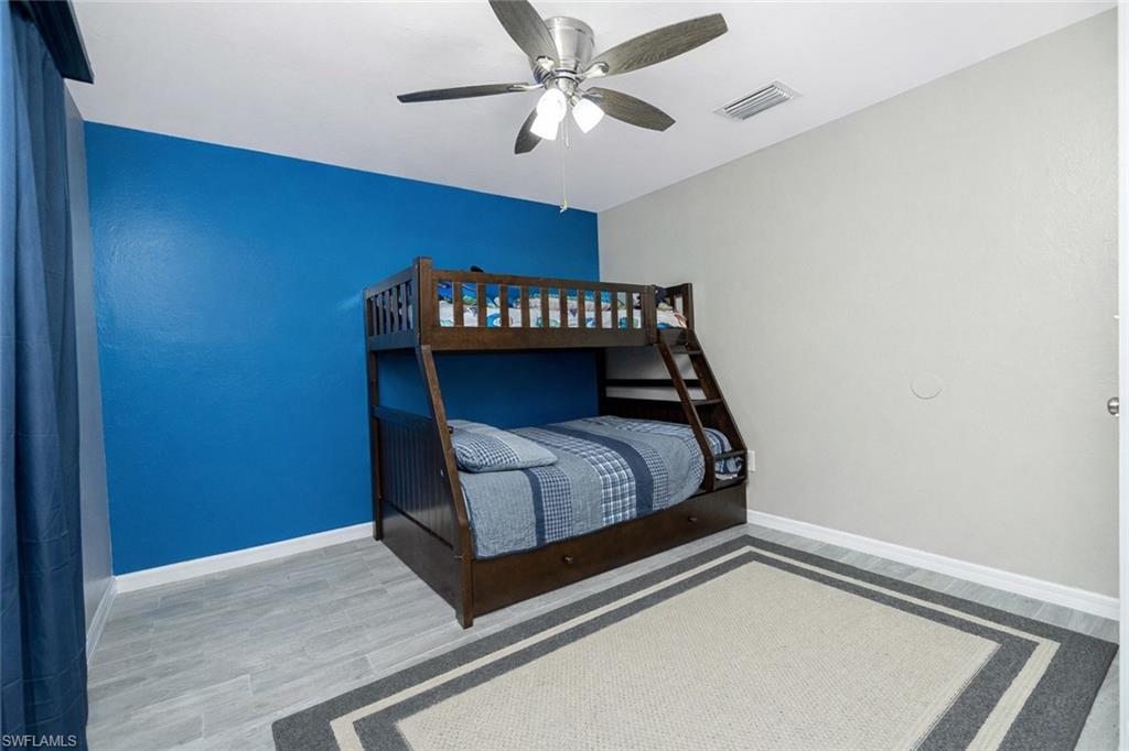 Bedroom featuring light wood-type flooring and ceiling fan